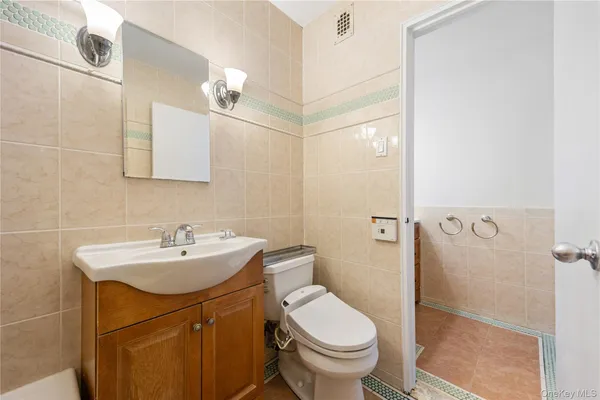 a bathroom with a sink toilet and mirror