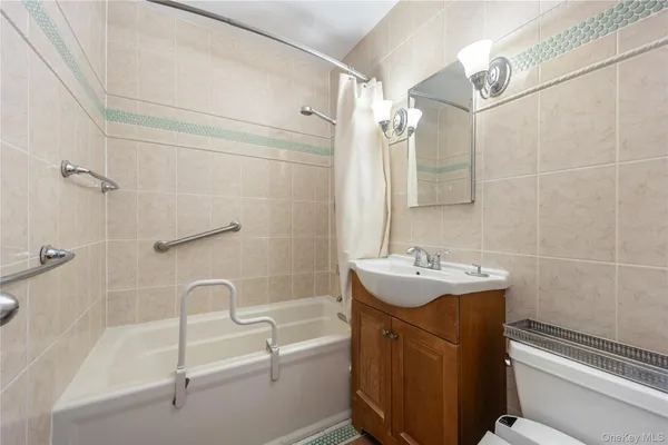 a bathroom with a sink mirror toilet and bathtub