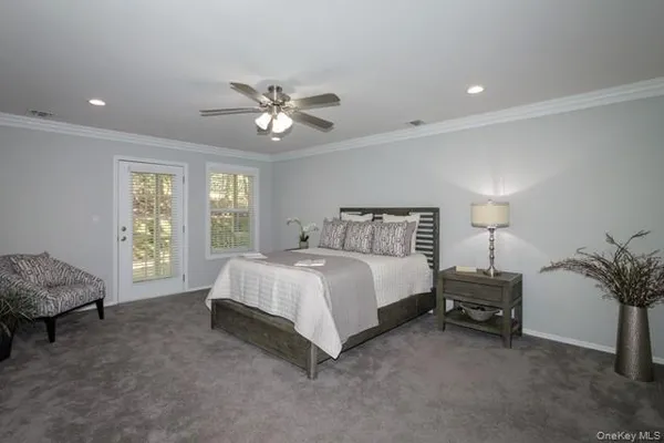 a bedroom with a bed and a potted plant