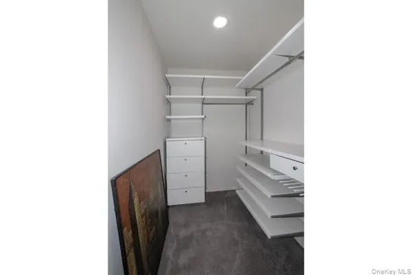 a view of walk in closet with white walls