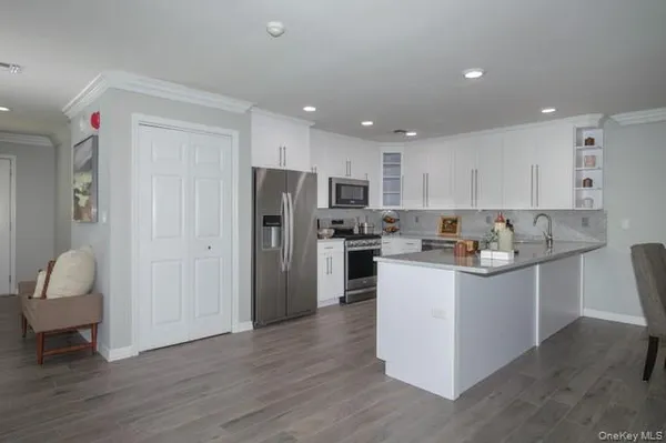 a kitchen with white cabinets and stainless steel appliances