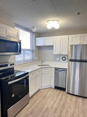a kitchen with a sink stove and refrigerator