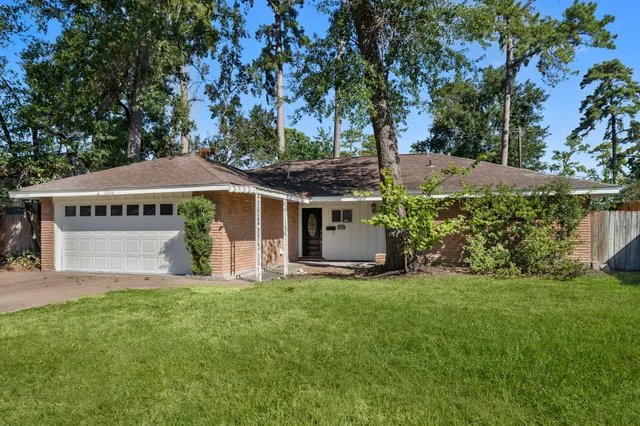 a view of a house with a yard and sitting area