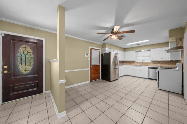 a kitchen with stainless steel appliances granite countertop a refrigerator and a sink