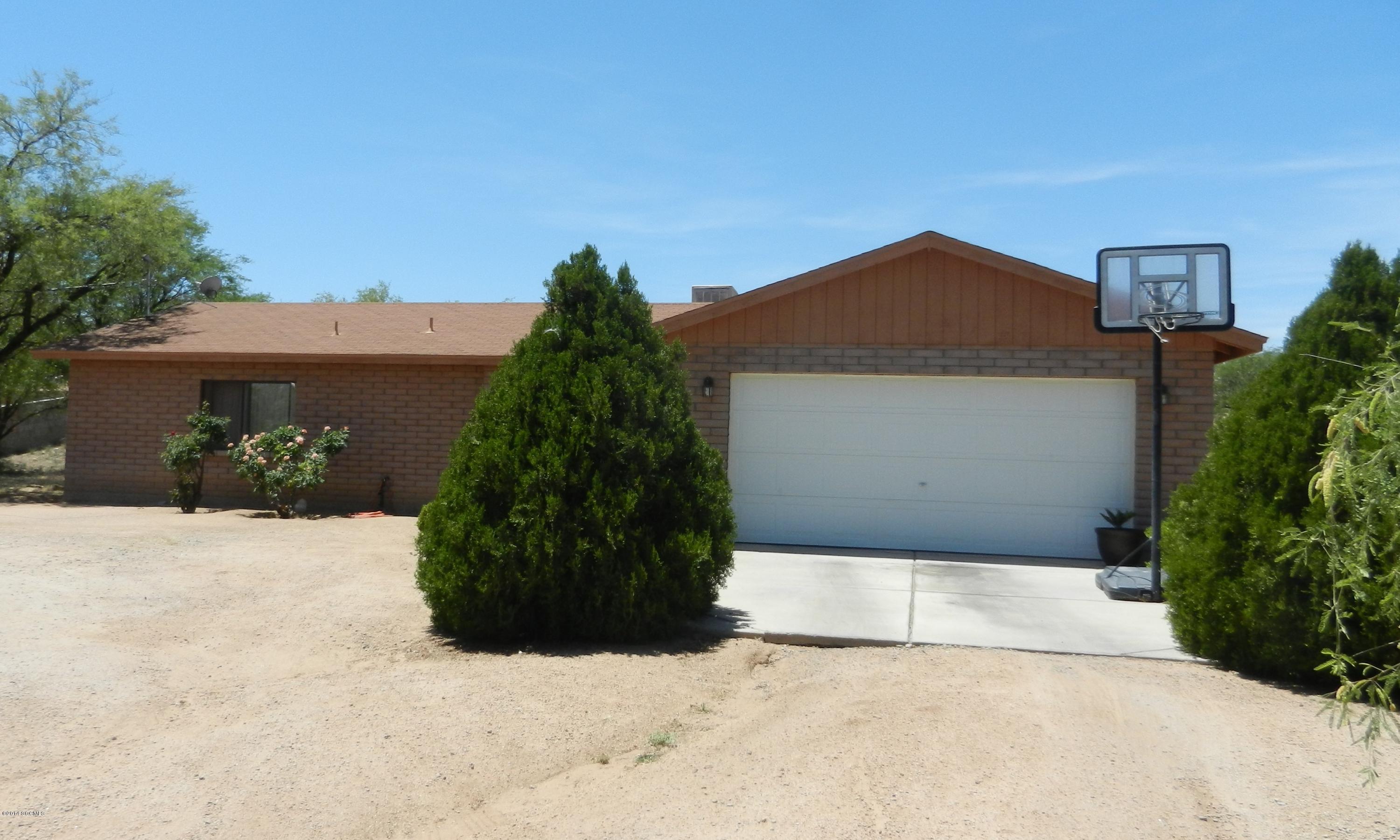 916 Paseo Queretaro Rio Rico, AZ 85648 - Photo 1 of 1 a front view of a house with a yard and garage