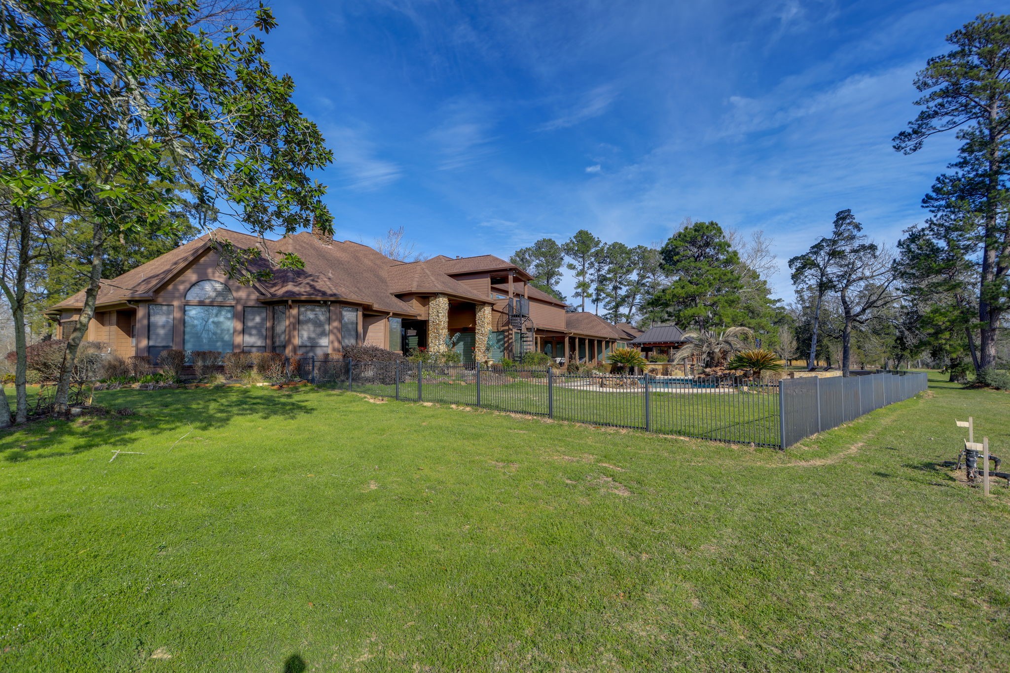 10210 Stidham Road Conroe, TX 77302 - Photo 29 of 39 a view of a house with a big yard and large trees