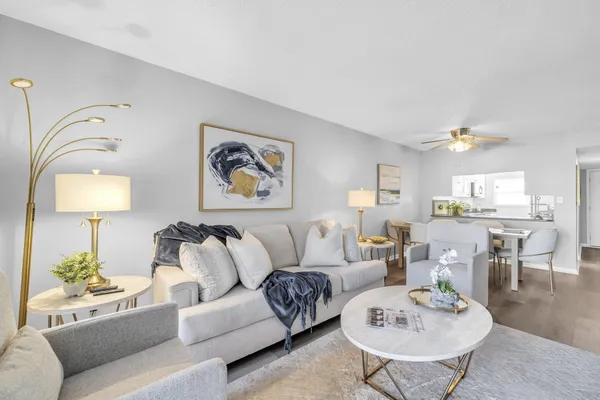 a living room with furniture and a lamp