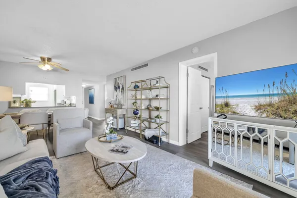 a living room with furniture and wooden floor