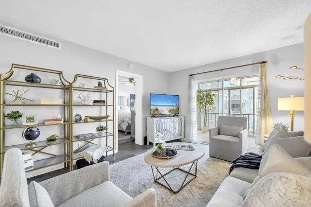 a living room with furniture cabinets and a window