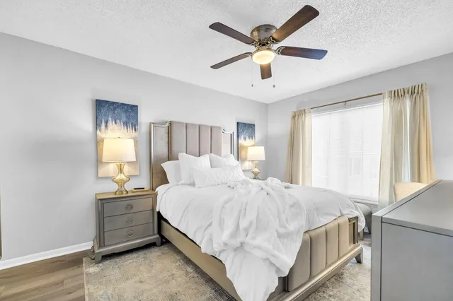 a bedroom with a bed and a large window