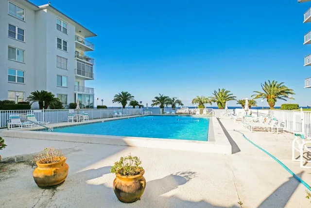 a view of a swimming pool with a lounge chair