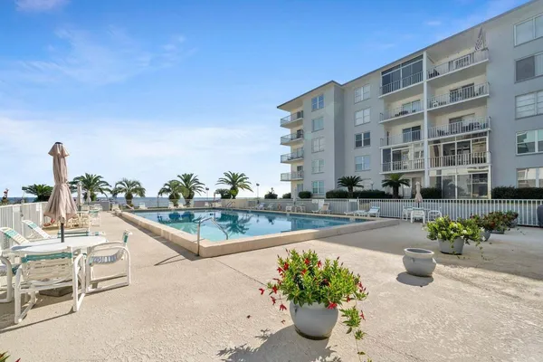 a view of building with yard and outdoor seating