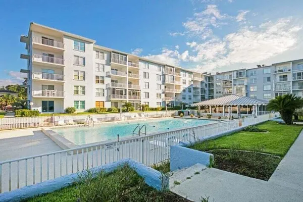 a view of a swimming pool with a yard