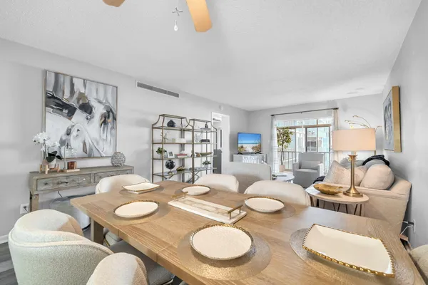 a dining room with furniture and wooden floor