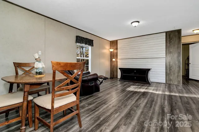 a living room with furniture a fireplace and a table