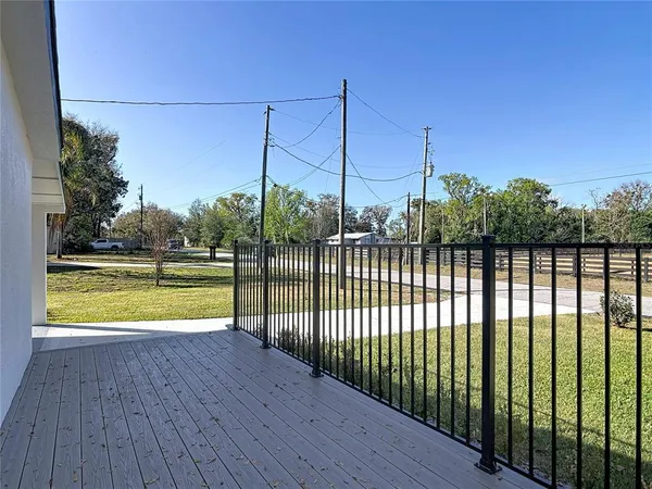 a view of a balcony with a floor to ceiling window and wooden fence