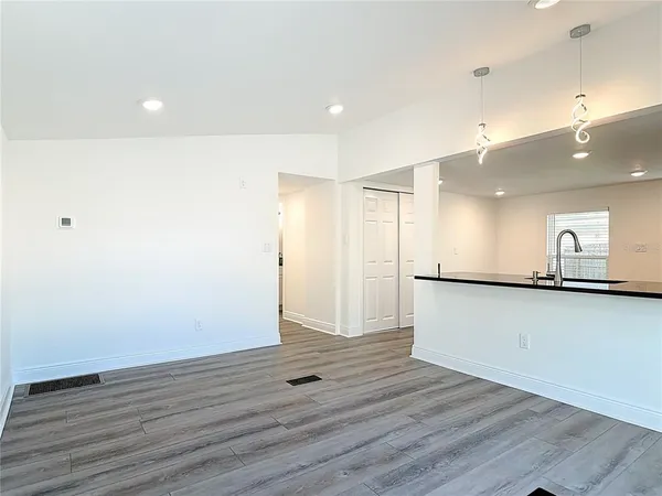 a view of a kitchen with wooden floor and a sink