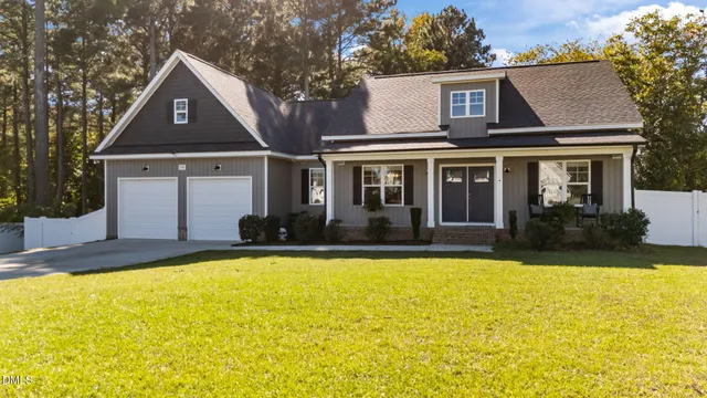 a front view of house with yard and swimming pool