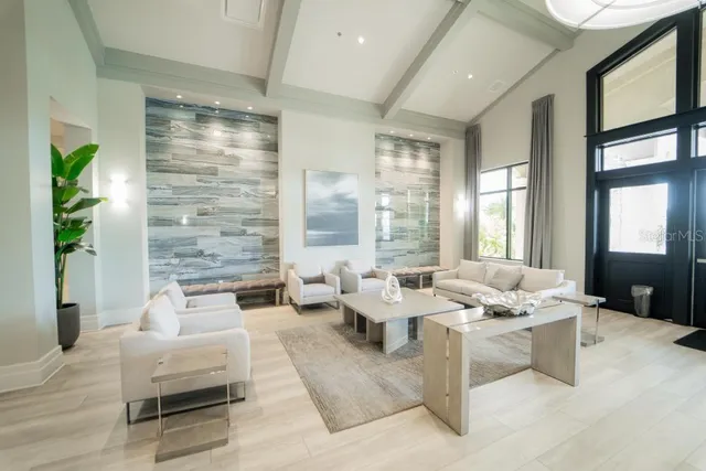 a living room with furniture and large windows