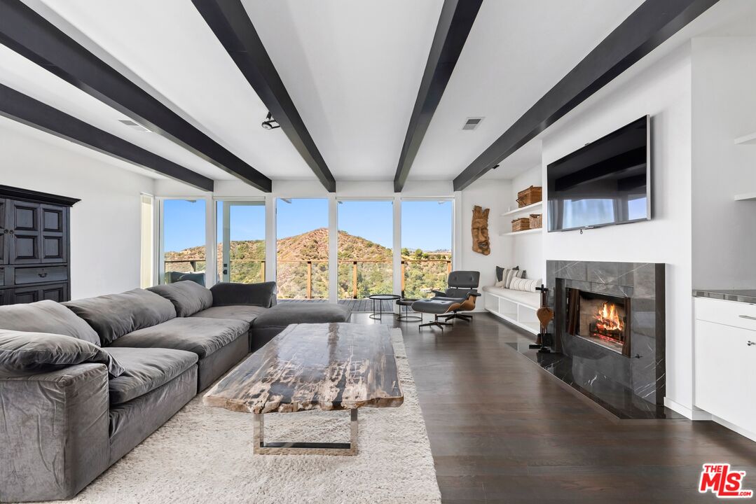 a living room with furniture fireplace and a flat screen tv