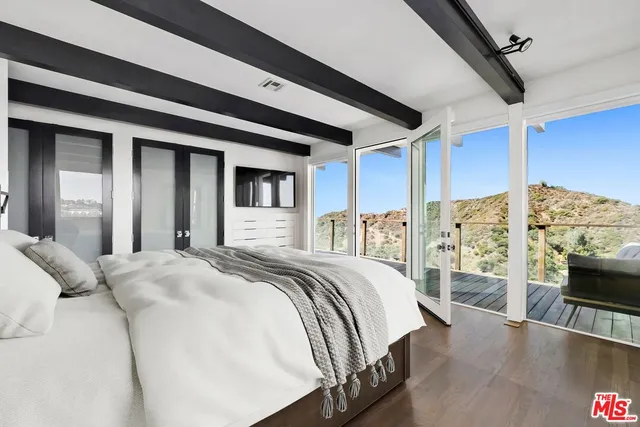 a bed sitting in a bedroom next to a window