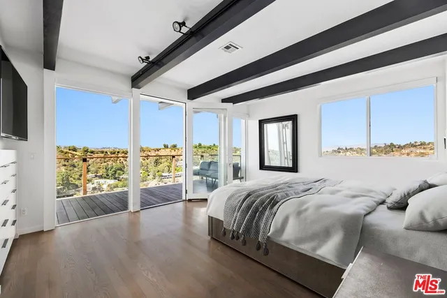 a spacious bedroom with a large bed and a window