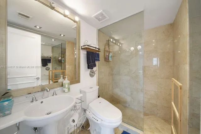 a bathroom with a sink toilet and shower