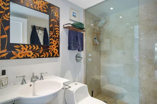 a bathroom with a sink toilet and shower