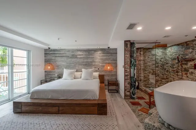 a bedroom with a large bed and a chandelier