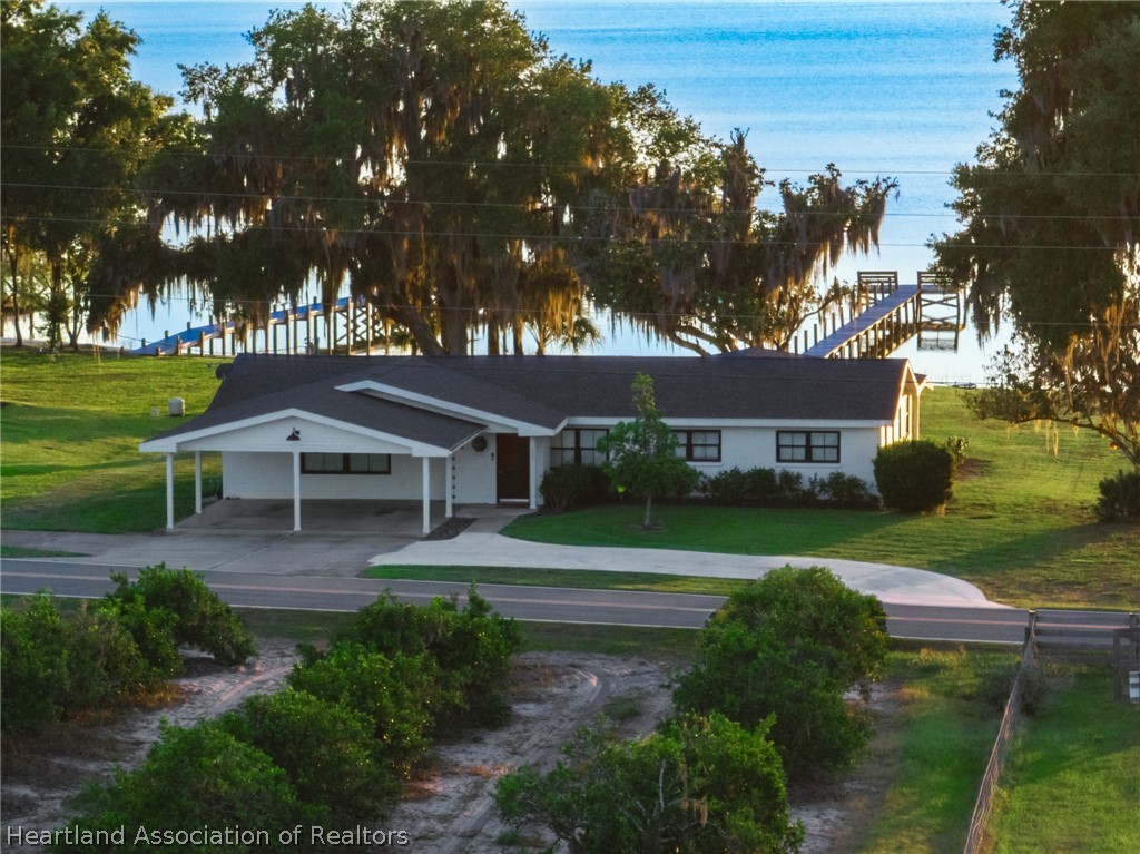 1843 South Lake Reedy Boulevard Frostproof, FL 33843 - Photo 1 of 50 a front view of a house with a yard and trees