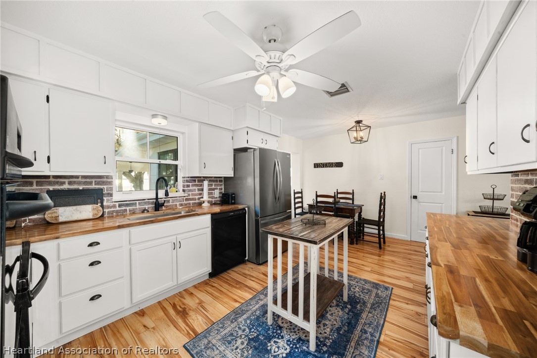 1843 South Lake Reedy Boulevard Frostproof, FL 33843 - Photo 19 of 50 a kitchen with granite countertop a table chairs stove and cabinets