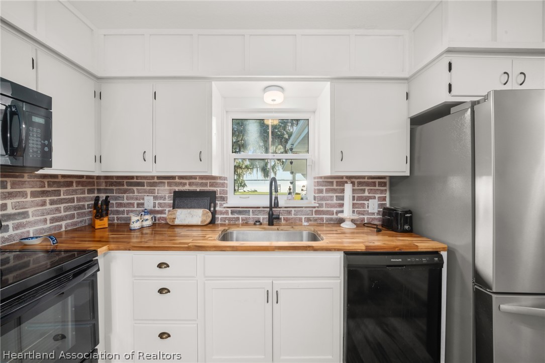 1843 South Lake Reedy Boulevard Frostproof, FL 33843 - Photo 20 of 50 a kitchen with a refrigerator and a sink