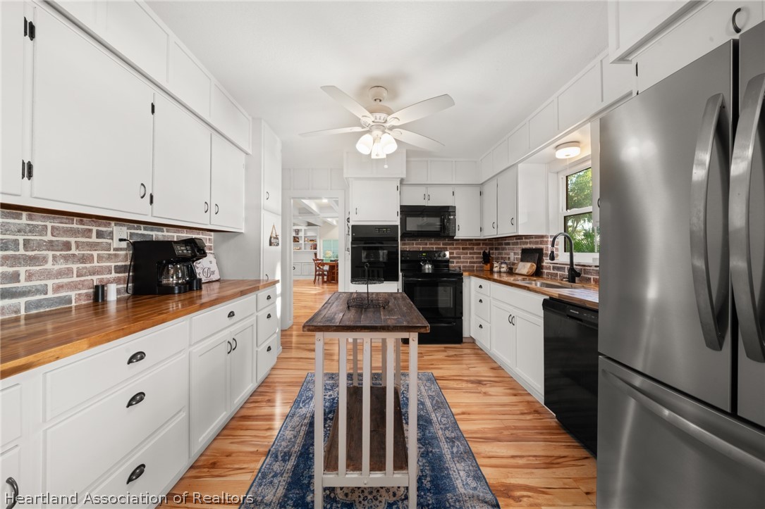 1843 South Lake Reedy Boulevard Frostproof, FL 33843 - Photo 23 of 50 a kitchen with stainless steel appliances a refrigerator sink and cabinets