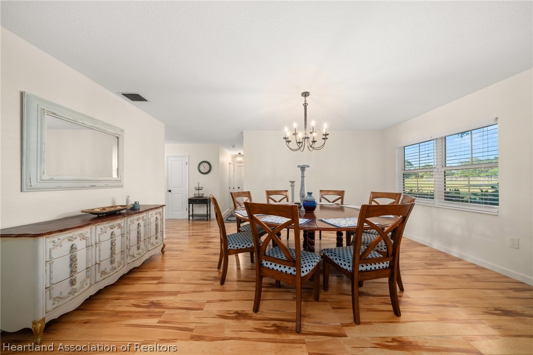 1843 South Lake Reedy Boulevard Frostproof, FL 33843 - Photo 25 of 50 a view of a dining room with furniture window and wooden floor
