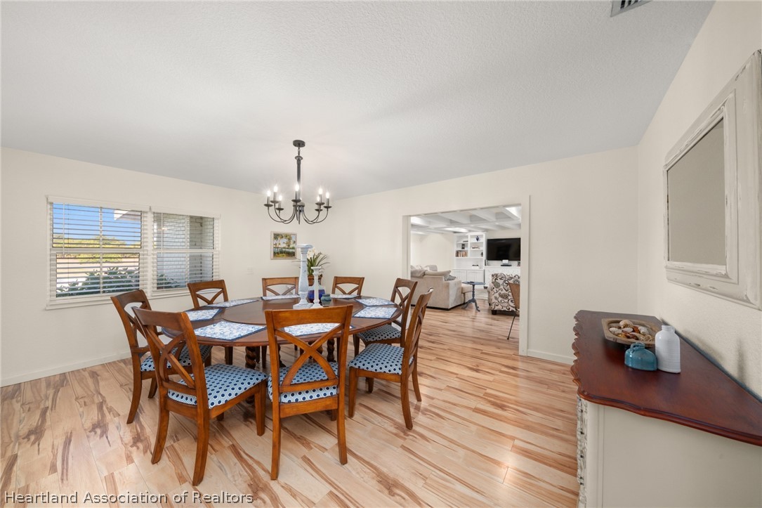 1843 South Lake Reedy Boulevard Frostproof, FL 33843 - Photo 27 of 50 a view of a dining room with furniture and wooden floor