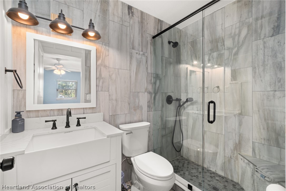 1843 South Lake Reedy Boulevard Frostproof, FL 33843 - Photo 34 of 50 a bathroom with a sink toilet a mirror and shower