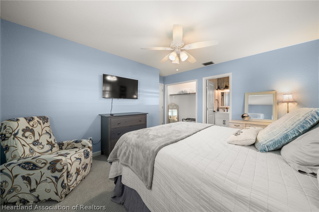 1843 South Lake Reedy Boulevard Frostproof, FL 33843 - Photo 36 of 50 a bedroom with a bed and a flat screen tv