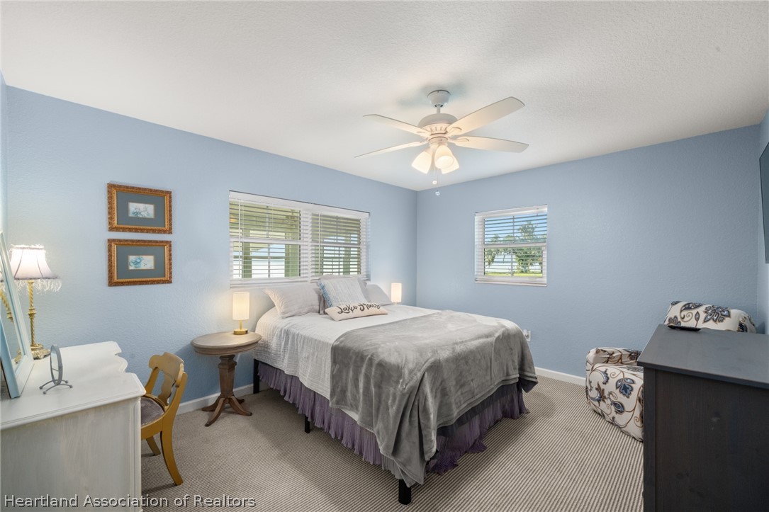 1843 South Lake Reedy Boulevard Frostproof, FL 33843 - Photo 38 of 50 a bedroom with a bed table chair and a window