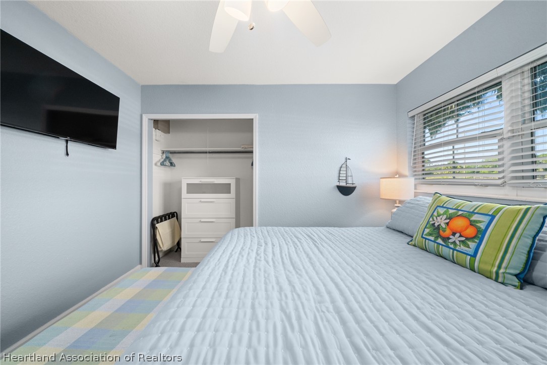 1843 South Lake Reedy Boulevard Frostproof, FL 33843 - Photo 40 of 50 a bedroom with a bed and flat screen tv