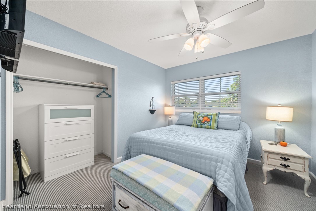 1843 South Lake Reedy Boulevard Frostproof, FL 33843 - Photo 41 of 50 a bedroom with a bed a chandelier and a window
