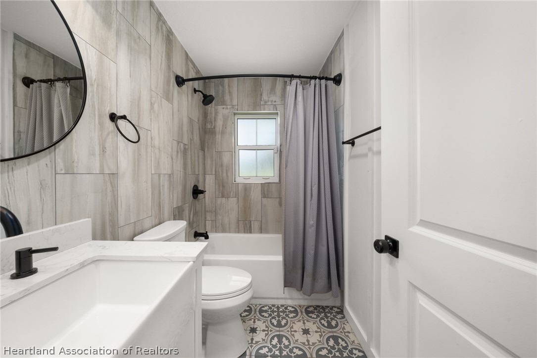 1843 South Lake Reedy Boulevard Frostproof, FL 33843 - Photo 42 of 50 a bathroom with a sink a toilet and shower