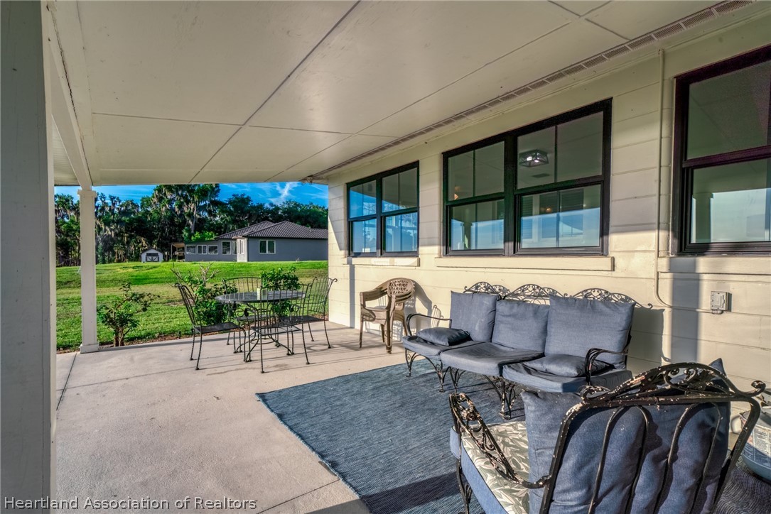 1843 South Lake Reedy Boulevard Frostproof, FL 33843 - Photo 47 of 50 a building outdoor space with patio furniture and potted plants