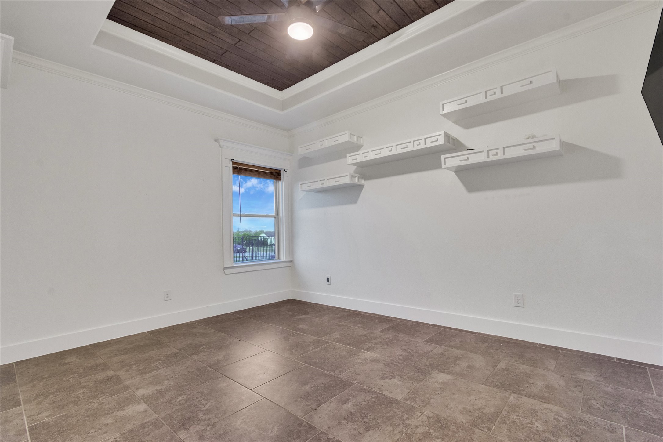 164 Peck Street Kyle, TX 78640 - Photo 13 of 19 Bedroom featuring crown molding, a wood tray ceiling, and ceiling fan