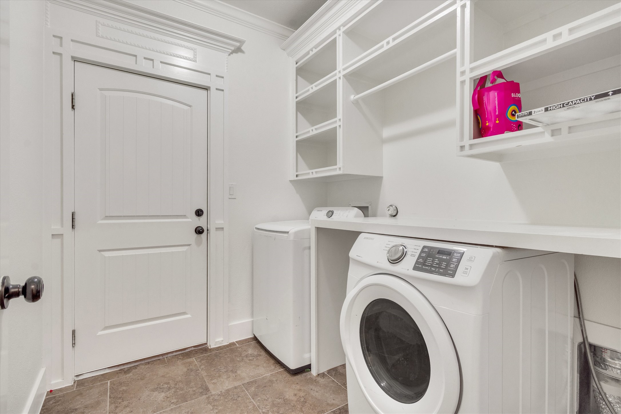 164 Peck Street Kyle, TX 78640 - Photo 16 of 19 Laundry room featuring crown molding and washing machine and clothes dryer