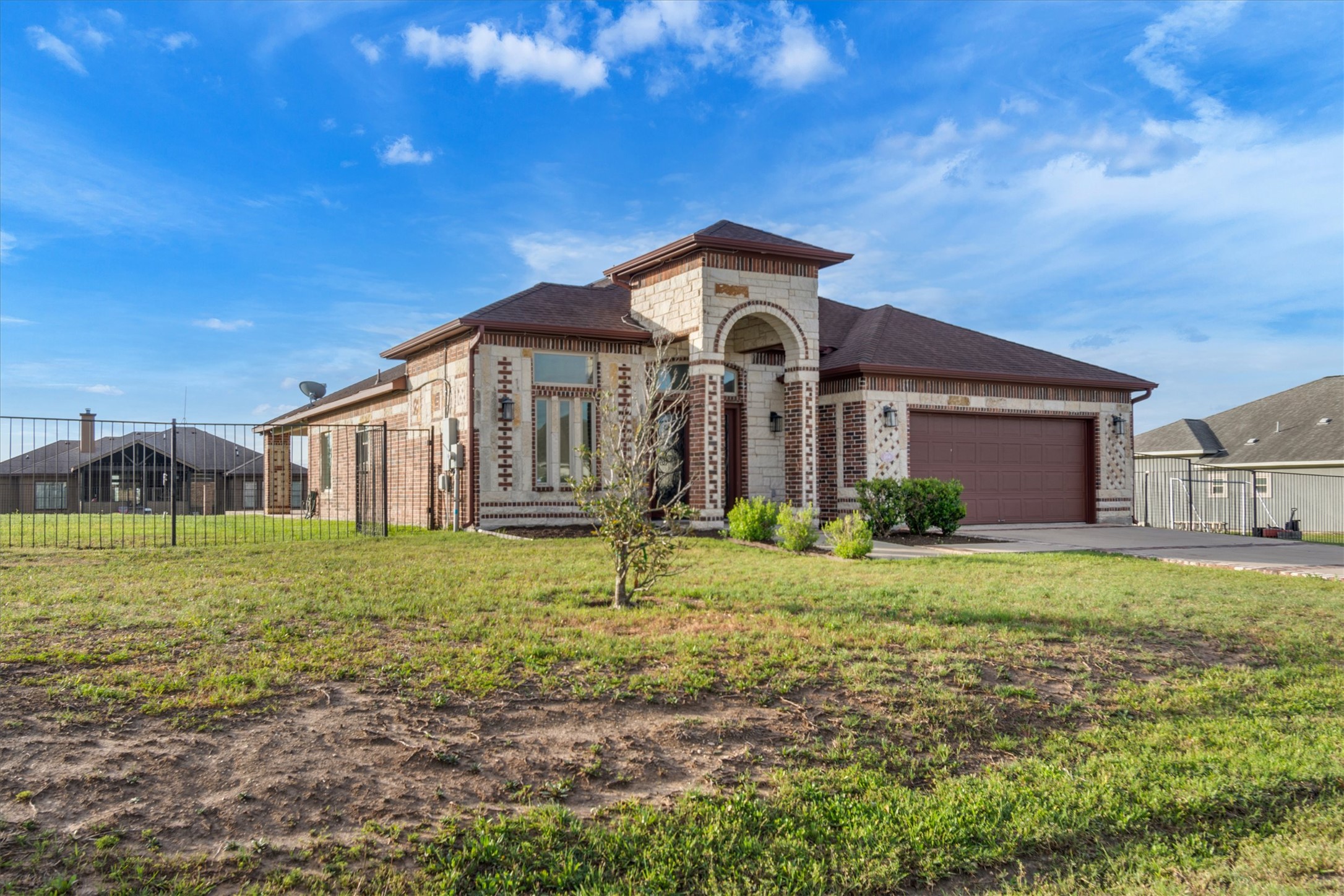 164 Peck Street Kyle, TX 78640 - Photo 3 of 19 View of front facade with brick siding, a garage, and driveway