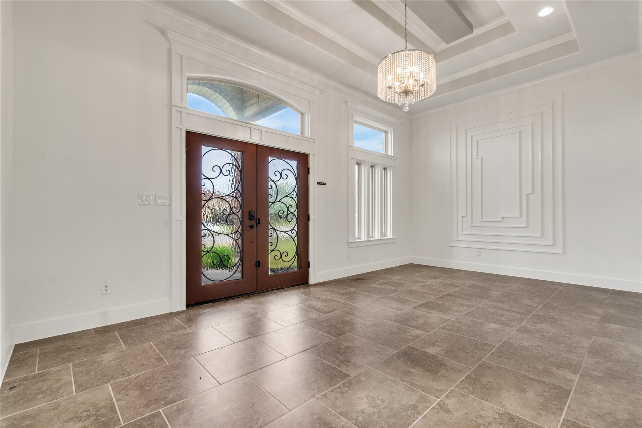 164 Peck Street Kyle, TX 78640 - Photo 4 of 19 Entrance foyer with french doors, hanging lights, crown molding, and a raised ceiling
