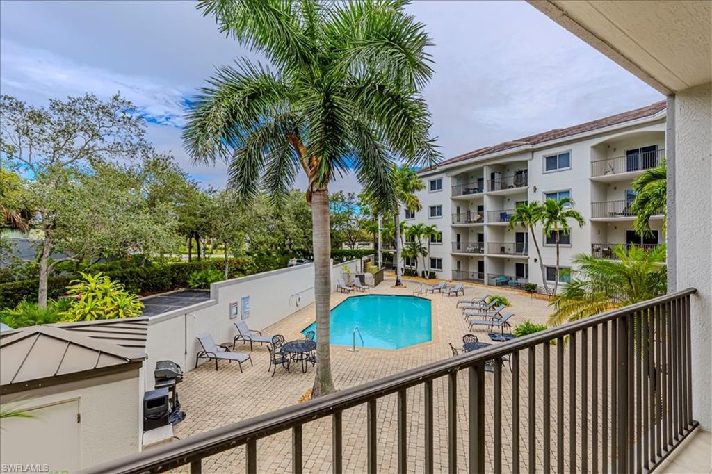 1100 Pine Ridge Road, Unit B106 Naples, FL 34108 - Photo 6 of 10 Community pool with a patio and a balcony