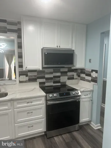 a kitchen with stainless steel appliances granite countertop a stove and a sink