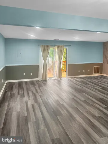 a view of room with window and wooden floor