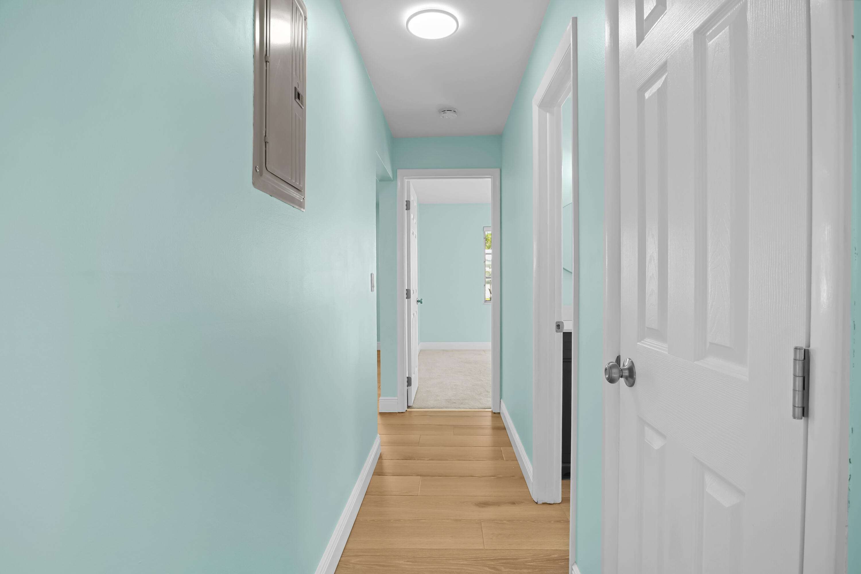 1308 Southwest 24th Street Boynton Beach, FL 33426 - Photo 14 of 19 a view of a hallway with wooden floor and a shower